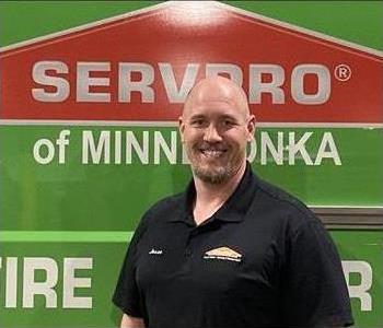 mad standing in front of a SERVPRO van