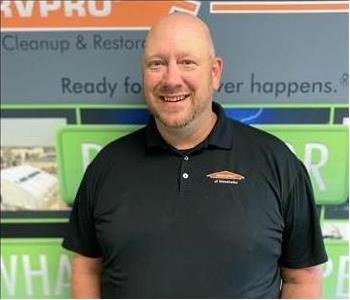 construction operations manager standing in front of a SERVPRO backdrop