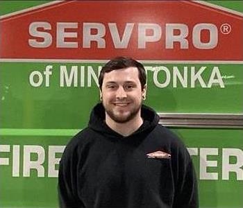 Joe smiling in front of a green SERVPRO Van